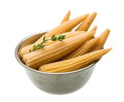 Baby corn in a bowl on white background photo