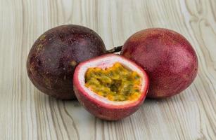 Passion fruit on wooden background photo
