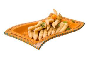 Baby corn on the plate and white background photo