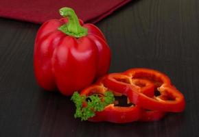 Red pepper on wooden background photo