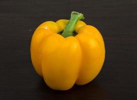 Yellow Bulgarian Pepper on wooden background photo