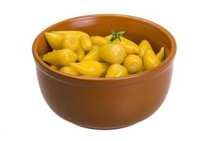 Marinated pepper in a bowl on white background photo