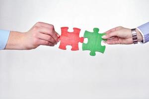 Group of business people assembling jigsaw puzzle photo