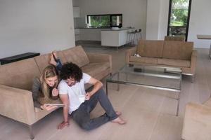 couple relaxing at  home with tablet computers photo