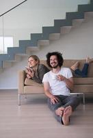 couple relaxing at  home with tablet computers photo