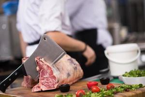 chef cutting big piece of beef photo