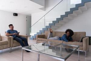 young multiethnic couple relaxes in the living room photo