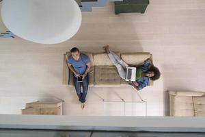 young multiethnic couple relaxes in the living room top view photo