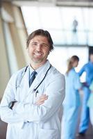 group of medical staff at hospital, handsome doctor in front of team photo