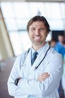 group of medical staff at hospital, handsome doctor in front of team photo