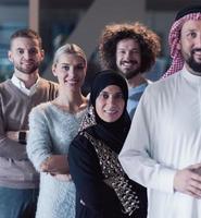Portrait of multiracial diverse group of businesspeople team standing behind older Arab team leader photo