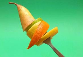 sliced fruits on fork photo