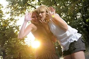 two girls together outside in dancing position ready for party photo