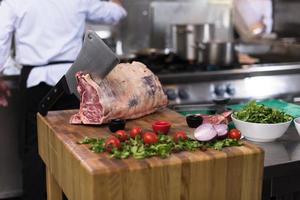 chef cutting big piece of beef photo