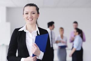 business woman standing with her staff in background photo