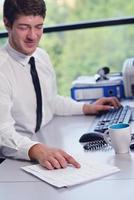 happy young business man at office photo