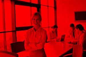 business woman with her staff in background at office photo