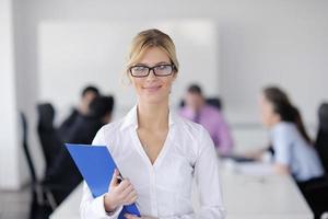 business woman standing with her staff in background photo