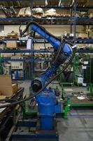 Turkey, 2022 - Automatic welding robot mechanical arm is working in the modern automobile parts factory. photo