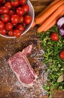 top view of raw steak on wooden table photo