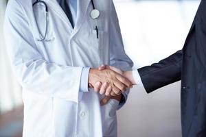 doctor handshake with a patient photo