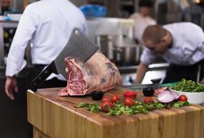 chef cutting big piece of beef photo