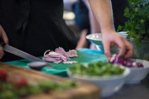 Chef  hands cutting the onion with knife photo