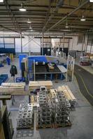 The first phase of metal and aluminum processing. Processed products from CNC machines stacked on a pallet in a large modern factory photo