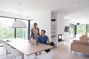 couple using laptop at home photo