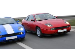 Isolated tuning cars racing on highway photo