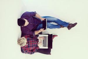 top view of  couple working on laptop computer at startup office photo