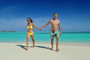 happy young  couple enjoying summer on beach photo