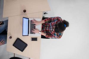 top view of young business woman working on laptop photo