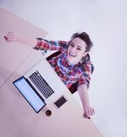 top view of young business woman working on laptop photo