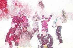 group of young people throwing snow in the air photo