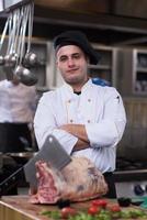 chef cutting big piece of beef photo