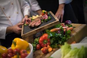 team cooks and chefs preparing meal photo