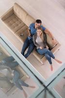 youg couple in living room with tablet top view photo