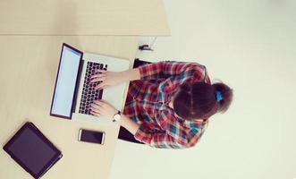 top view of young business woman working on laptop photo