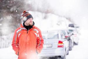 Portrait of young man on snowy winter day photo