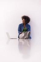 african american woman sitting on floor with laptop photo