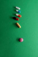 pills on green background photo