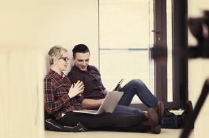 startup business, couple working on laptop computer at office photo