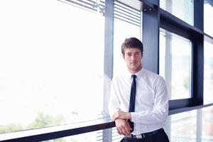 business man  on a meeting in offce with colleagues in background photo