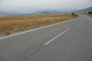 road through the green field photo