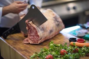 chef cutting big piece of beef photo