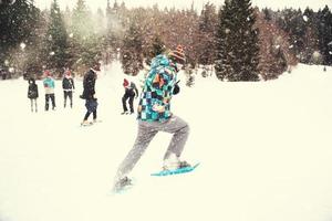 group of young people having a running competition on winter day photo