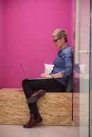 woman in crative box working on laptop photo
