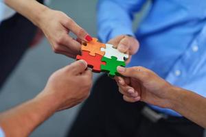 Group of business people assembling jigsaw puzzle photo