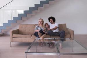 Young couple on the sofa watching television photo